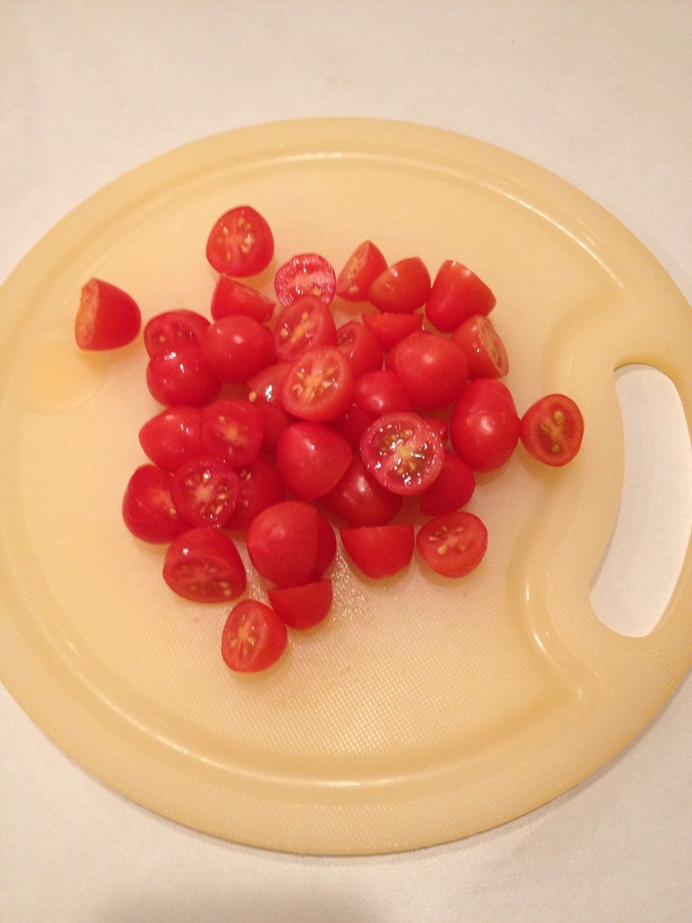 Slice grape tomatoes in half.