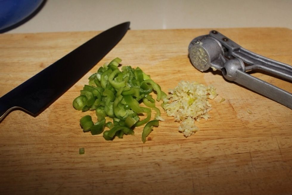 Slice hot green pepper and squash the garlic