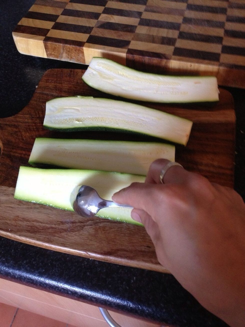 Slice in half and scoop out the seedy core using a teaspoon.