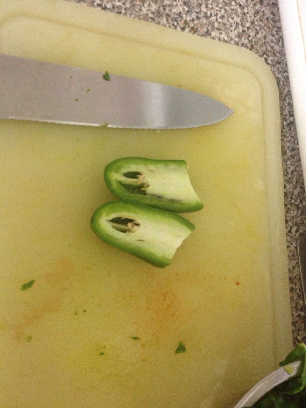 Slice in half first. This helps if you're a beginner using knives. It's easier to keep in place. NEVER cut food in your hand! It's very dangerous, so always use a hard surface or cutting board.