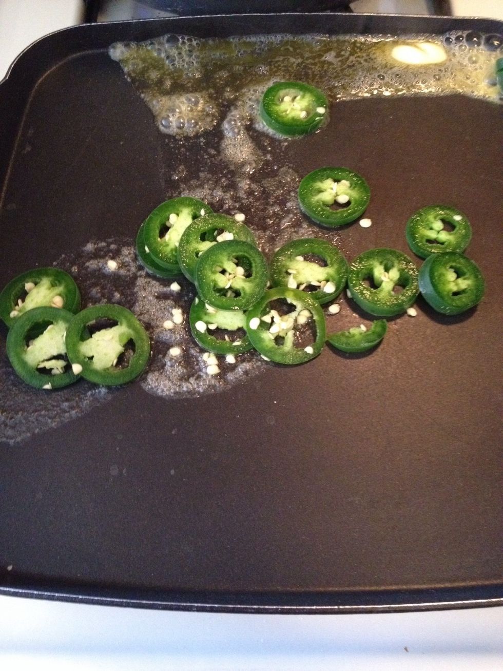 Slice jalape\u00f1os. Put on skillet and cook until tender