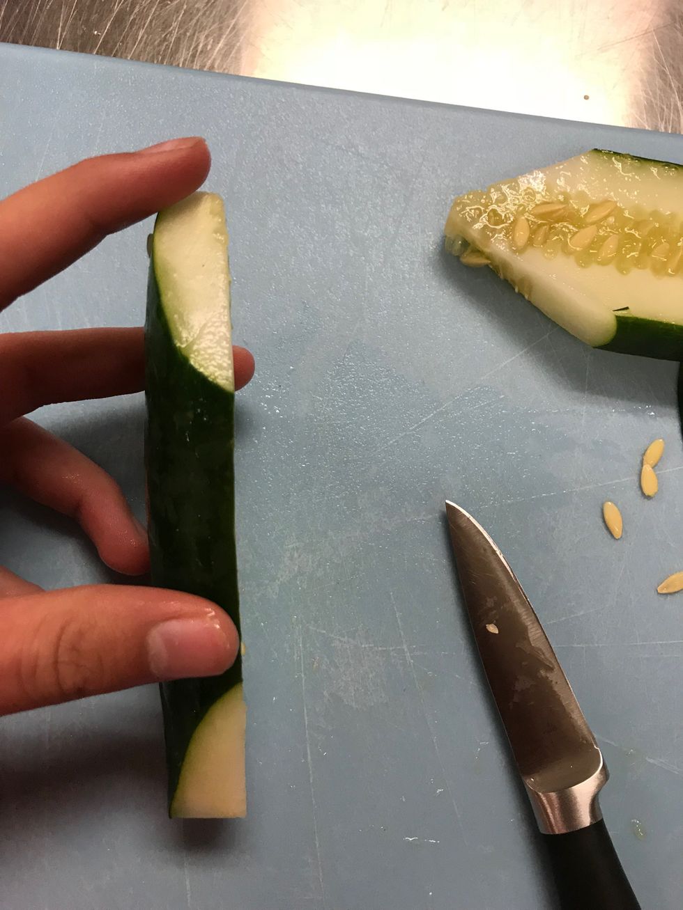 Slice off about a fourth of the side of the cucumber. Set the bigger half aside.