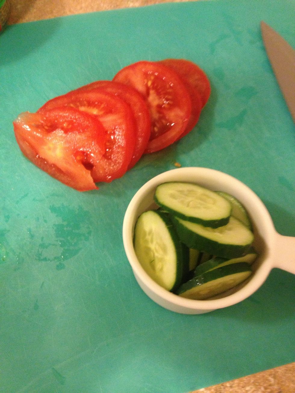 Slice one tomato and 1/2 cup cucumber