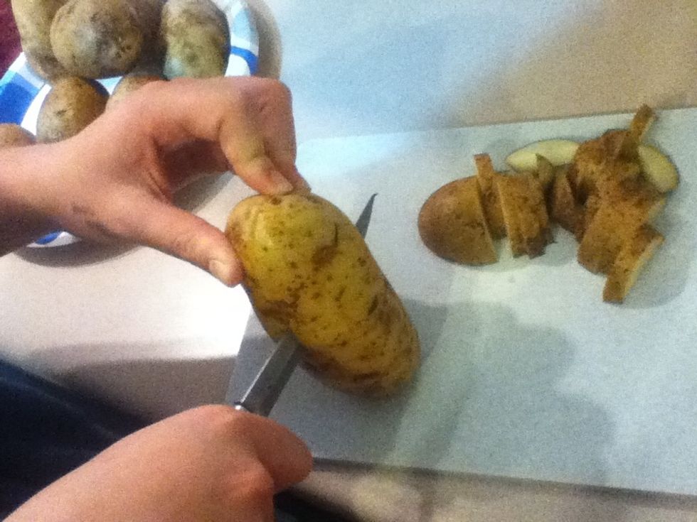 Slice potatoes vertically in half.