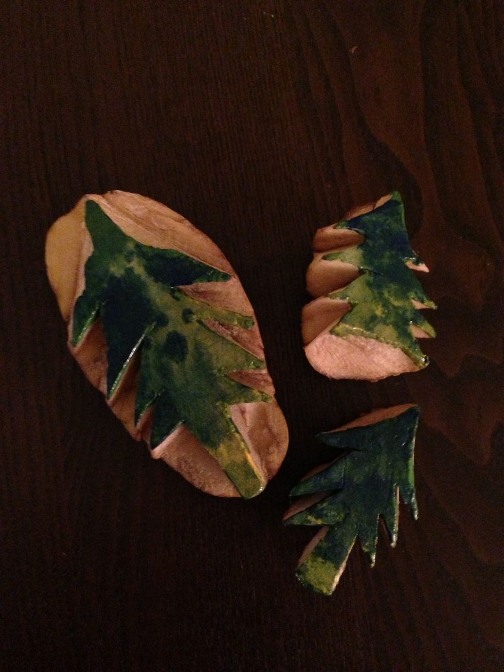 Slice raw potato in half and carve out your design. I made trees! Dip in paint. I used green, yellow and blue acrylic paint on a plate and mixed them gently.