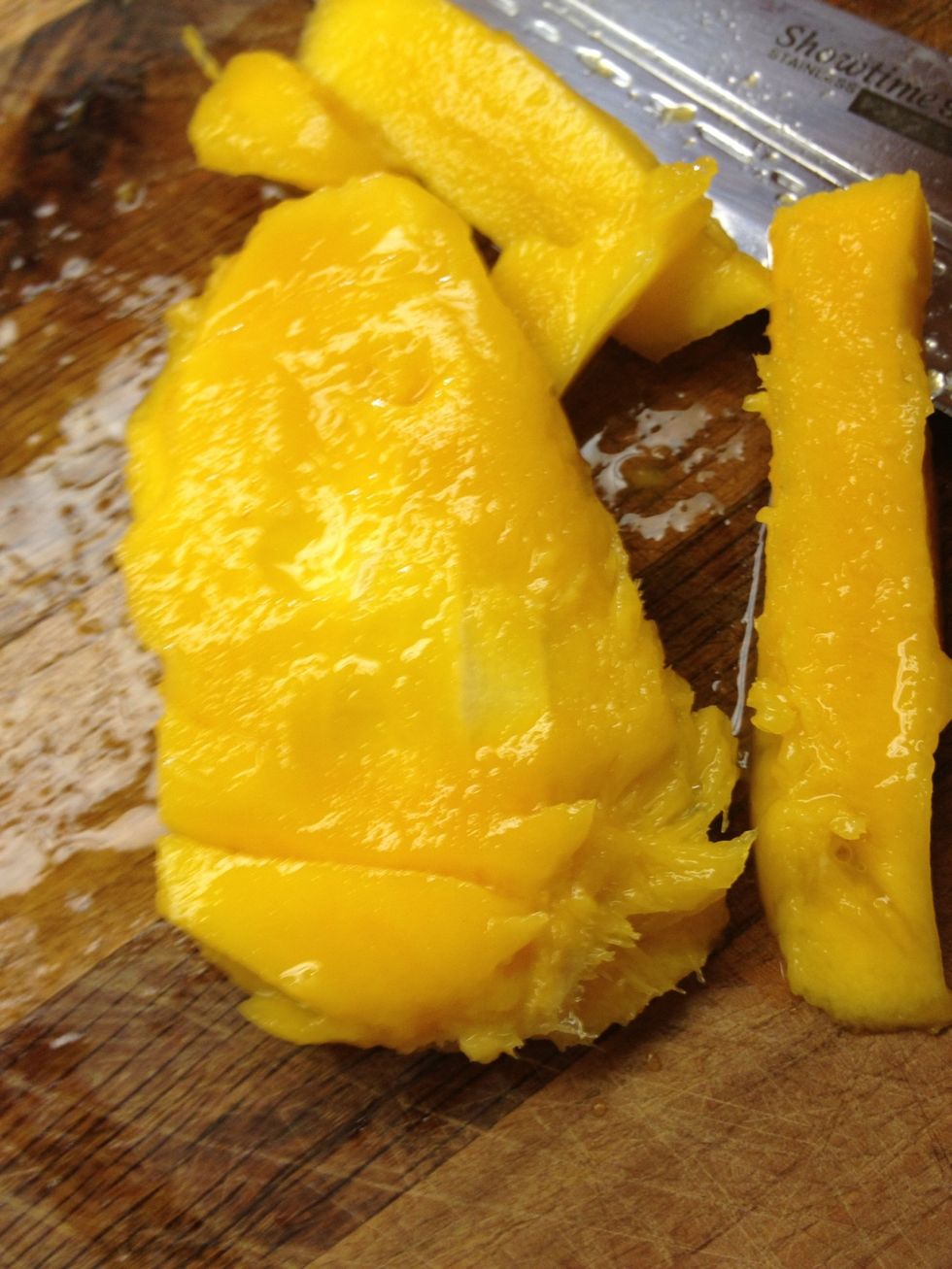 Slice remaining mango away from pit.  Stand over sink and slurp off what ever remains. Mmmmm! Sweet!!