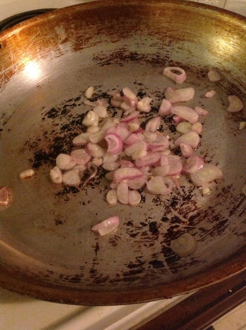Slice shallots and fry in oil on medium heat.