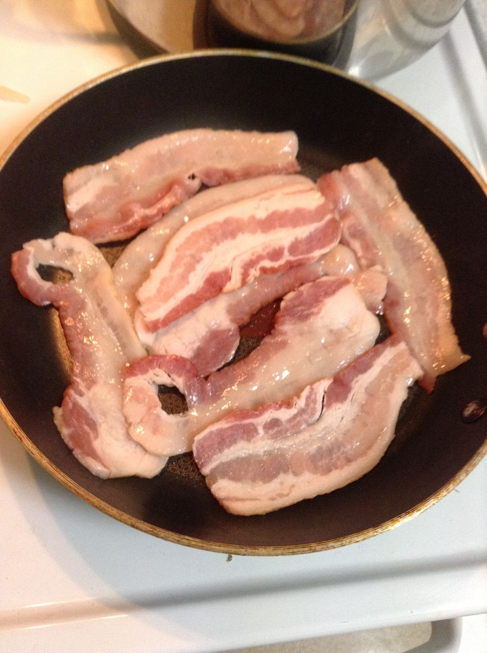 Slice the 4 pieces of bacon in half and cook