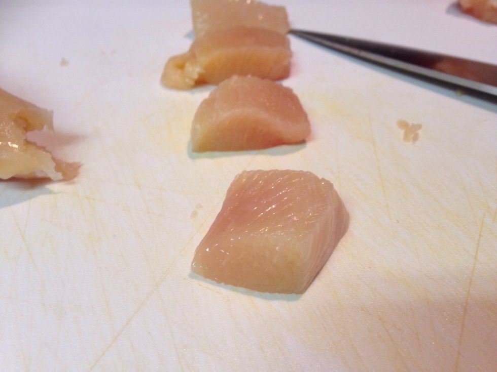 Slice the chicken breasts into 1 inch squares. Season the chicken with salt and pepper.