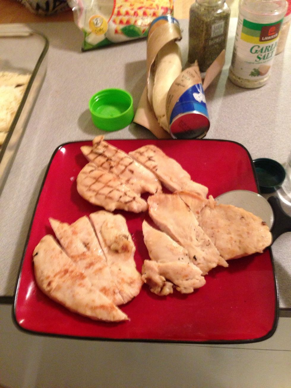 Slice the cooked chicken into sections.