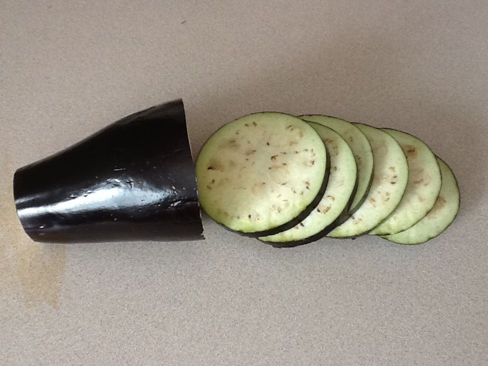 Slice the eggplant. You can remove the skin before slicing.