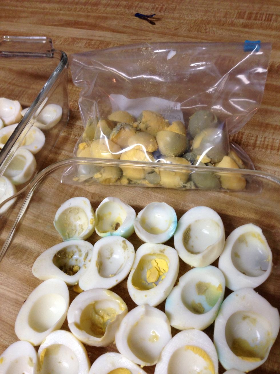 Slice the eggs in half lengthways. Place them in a dish. Pop out each of the yolks and put it in at least a quart sized zipper bag.