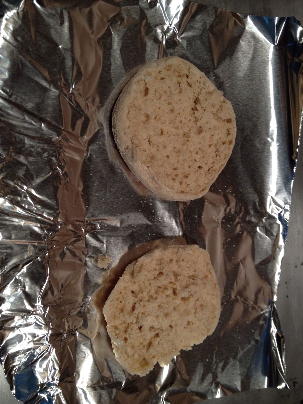 Slice the English muffin in half and place on a cookie sheet.