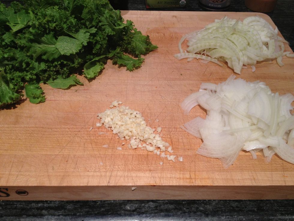 Slice the fennel and onion, mince the garlic and tear the mustard into bite sized pieces.