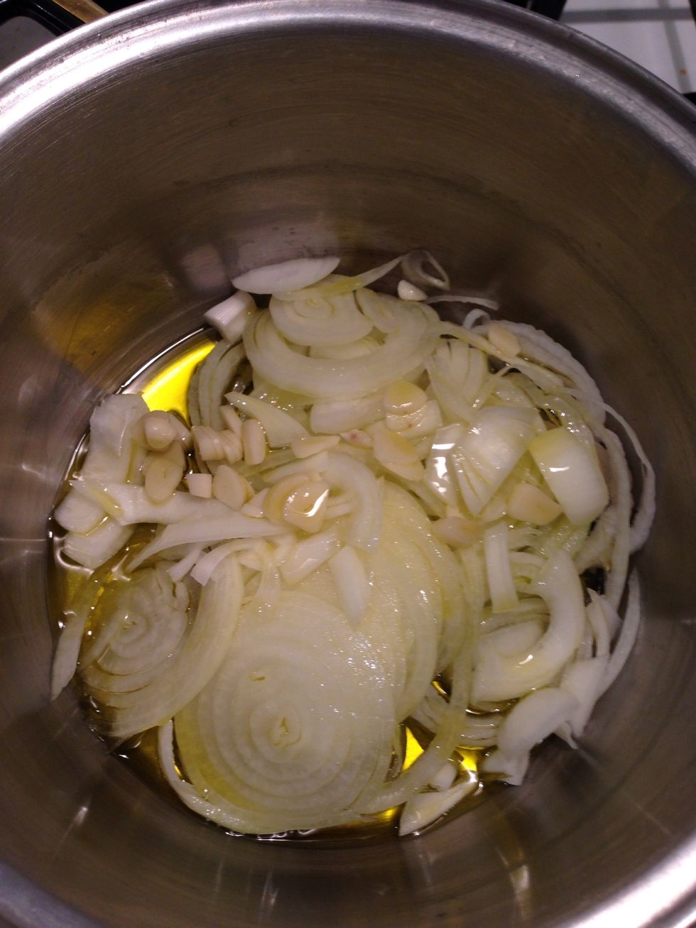 Slice the onions and the garlic and add a good olive oil to the mixture, covering the bottom of the pan entirely