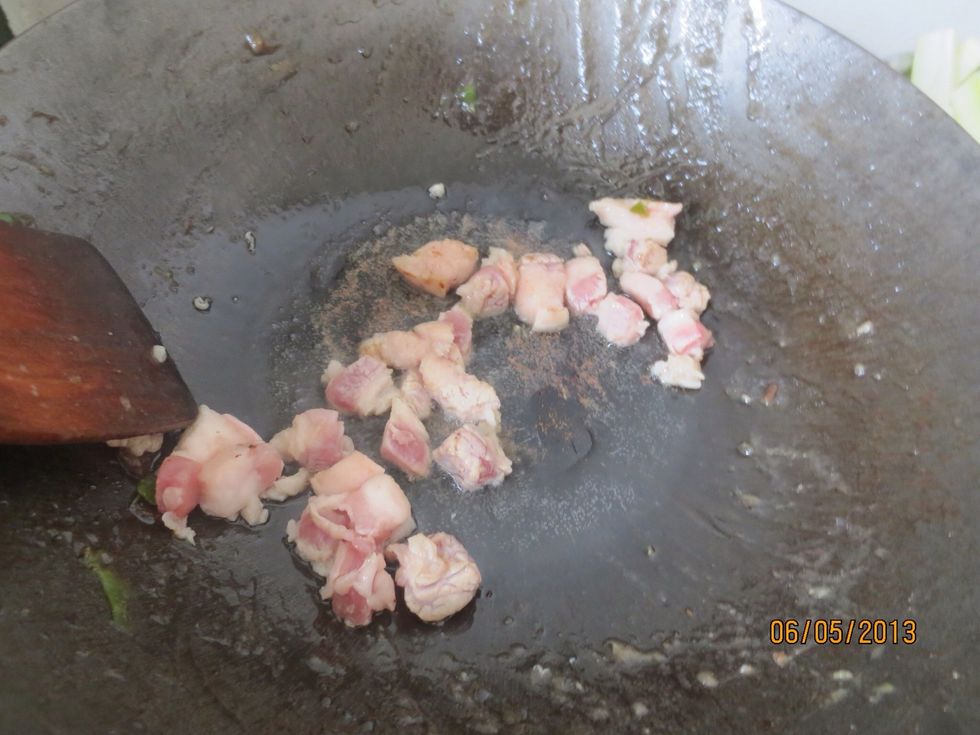 Slice the pork and add them to a wok with a little oil heated