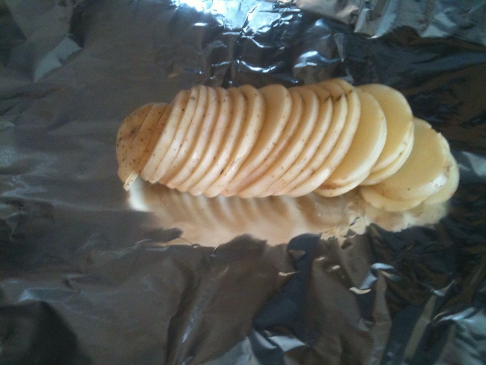 Slice the potatoes! Place them on a piece of aluminum foil. ( Heavy duty is better ) about a 10-12" piece.