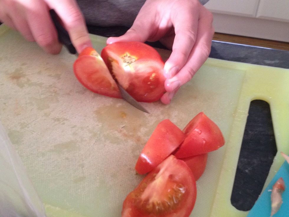Slice the tomato into eights. Take out core. Place in bowl.