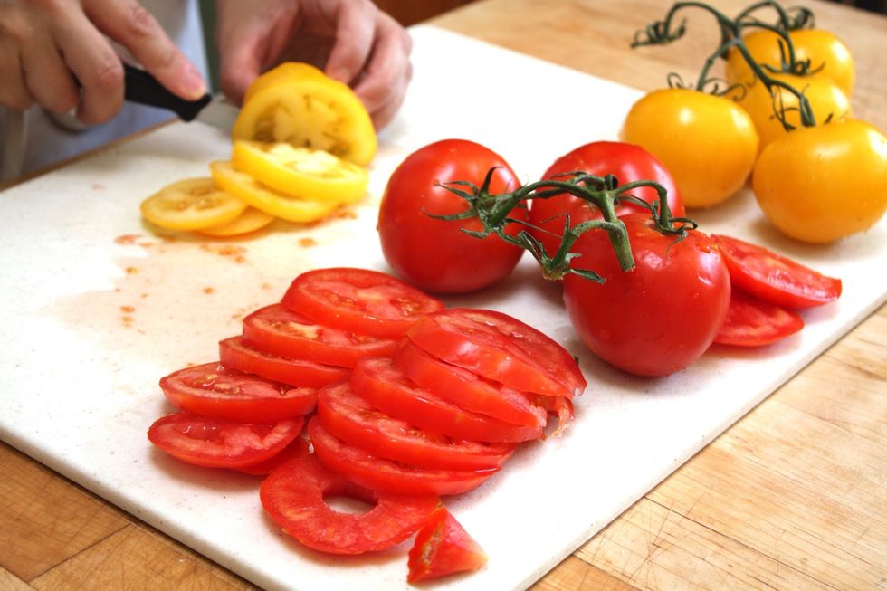 Slice the tomatoes evenly. Using different colored tomatoes will enhance the look of the finished tart.