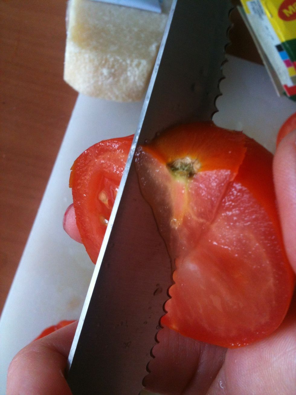 Slice the tomatoes in half and remove the hard part