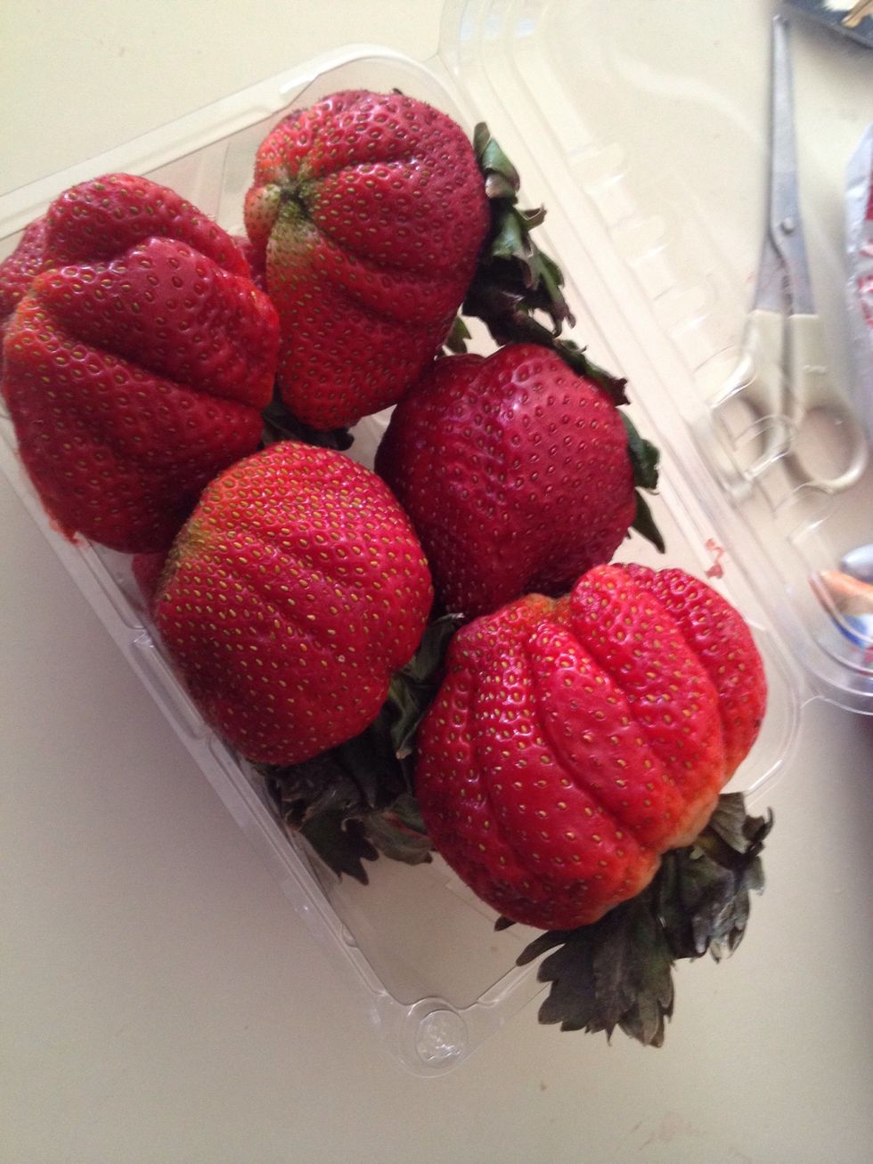 Slice up some fresh strawberries and place them on top of your cake.