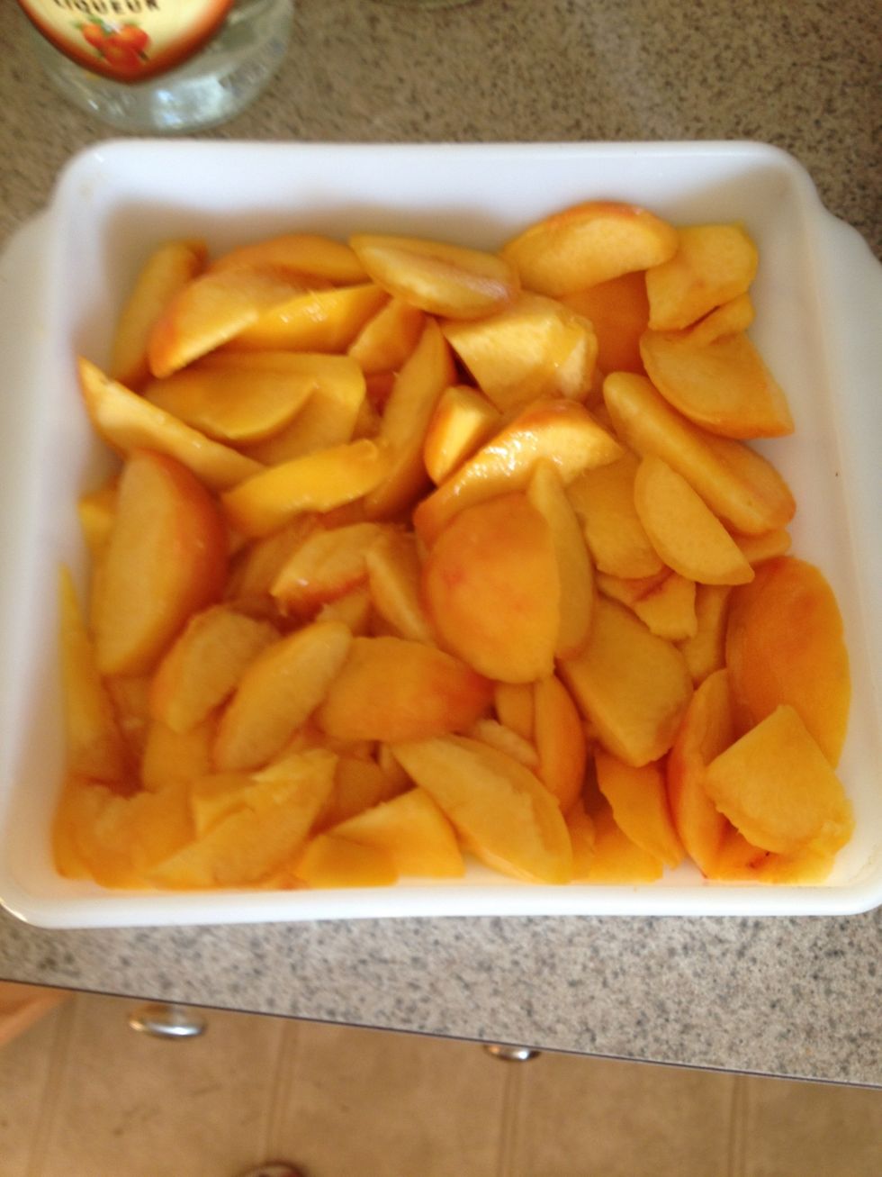 Slice up the peaches and fill the bottom of a 9 inch x 9 inch baking dish.