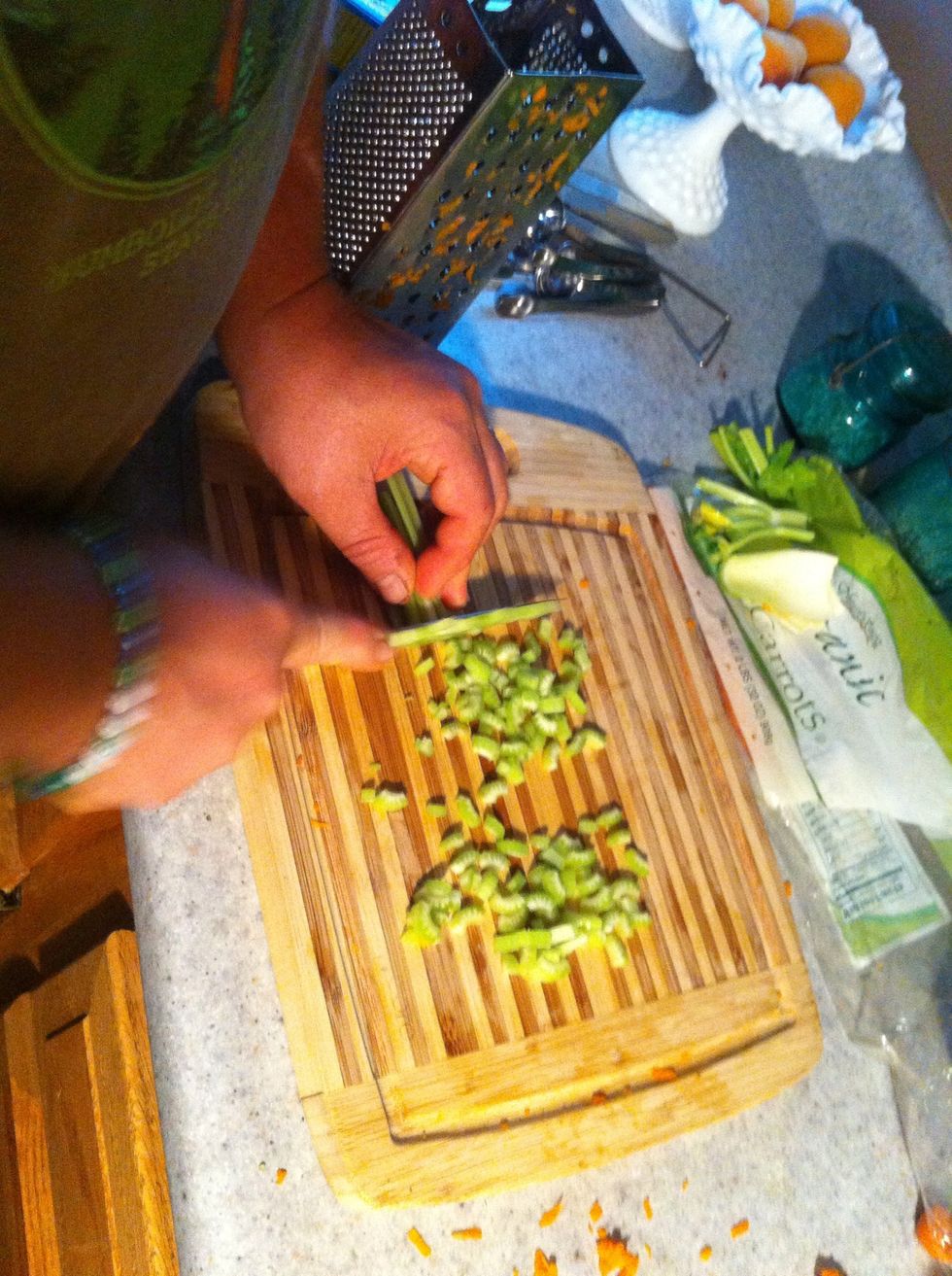 Slice washed celery lengthwise into 3's the pile and chop into small cubes...