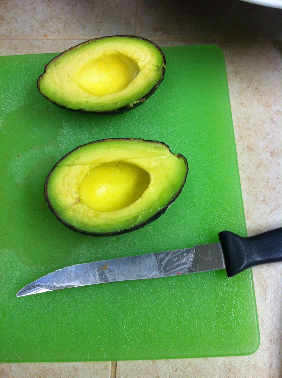 Slice your avocado in half, and remove the seed.