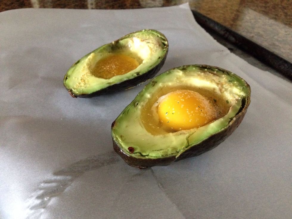 Slice your avocado in half and scoop out some of the insides so your egg can fit! I added a little garlic powder on top ;) pop into the oven for about 20 mins! Less if you like your yolk runny :)