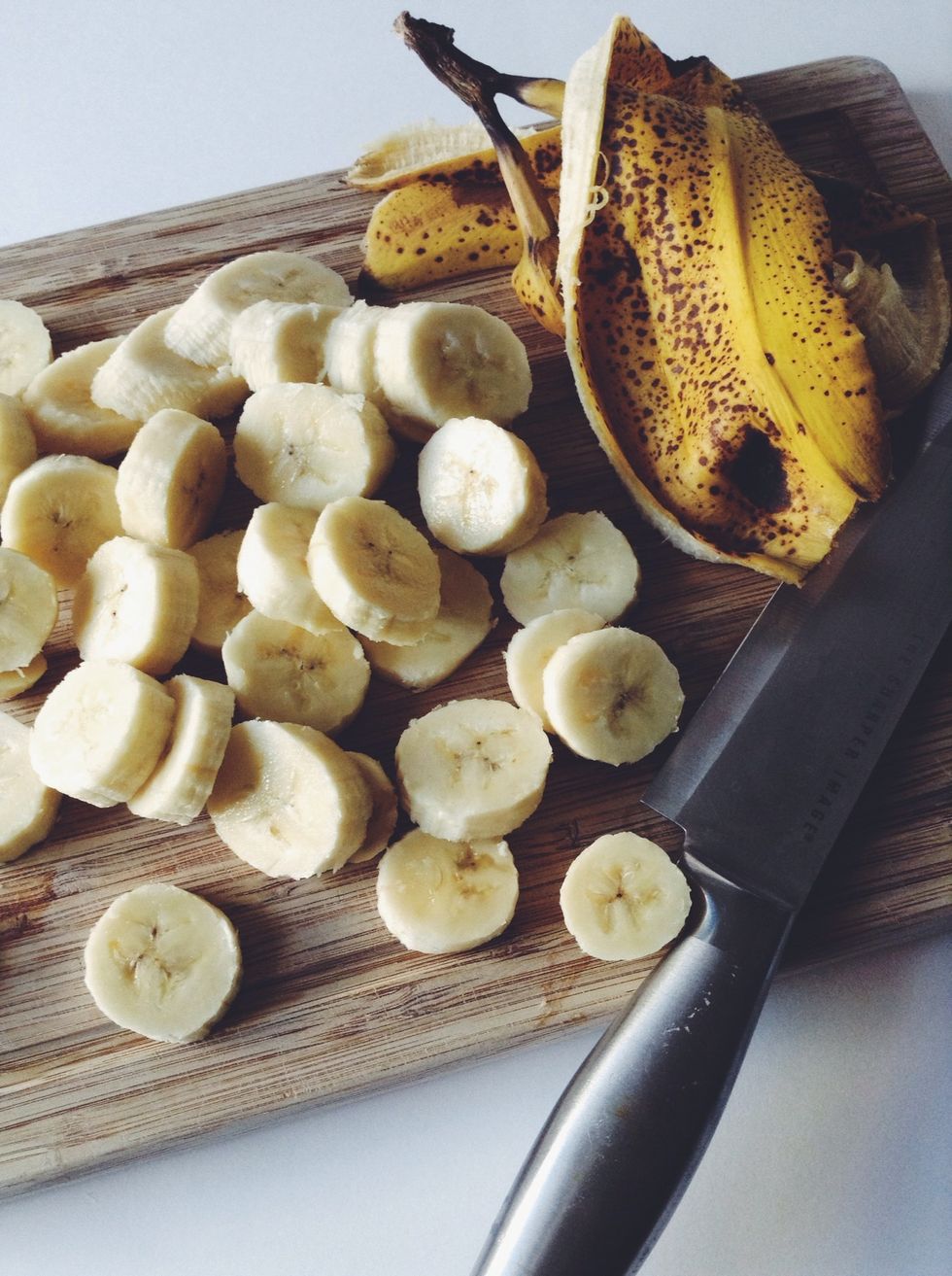 Slice your bananas into coins. I sliced them about 1/4 in. thick but the thinner you slice, the faster they freeze. Do this to all the bananas, however many you use. I used four.
