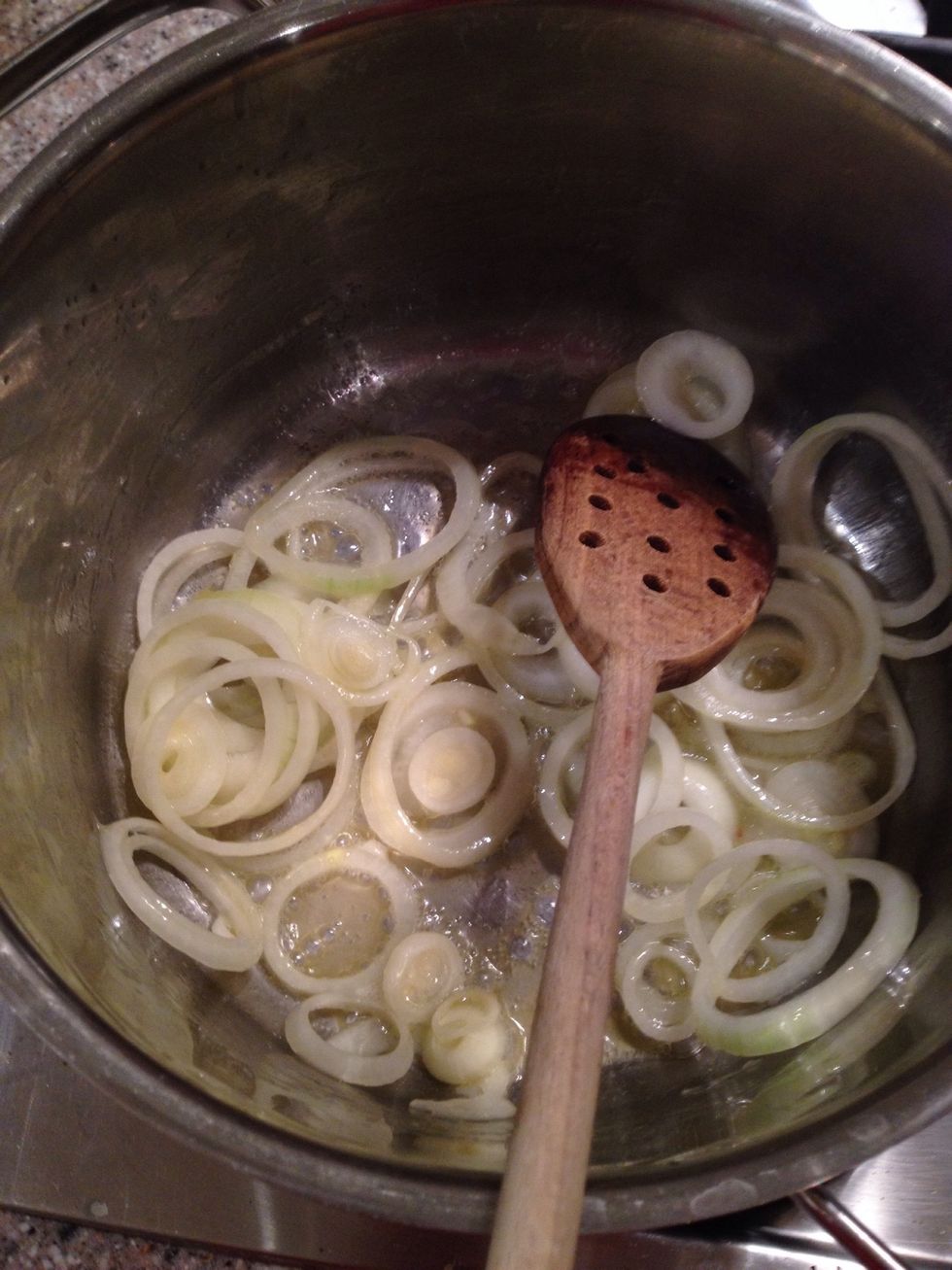 Slice your onions and fry them until they are translucent. Slice your potatoes and add them to the onions in the pot.