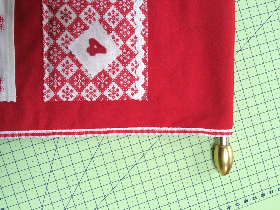 Slide a cafe rod into the openings at top and bottom . Cut a length of ribbon as a hanger