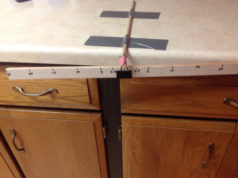 Slide a wedge-shaped eraser on the end of the dowel.