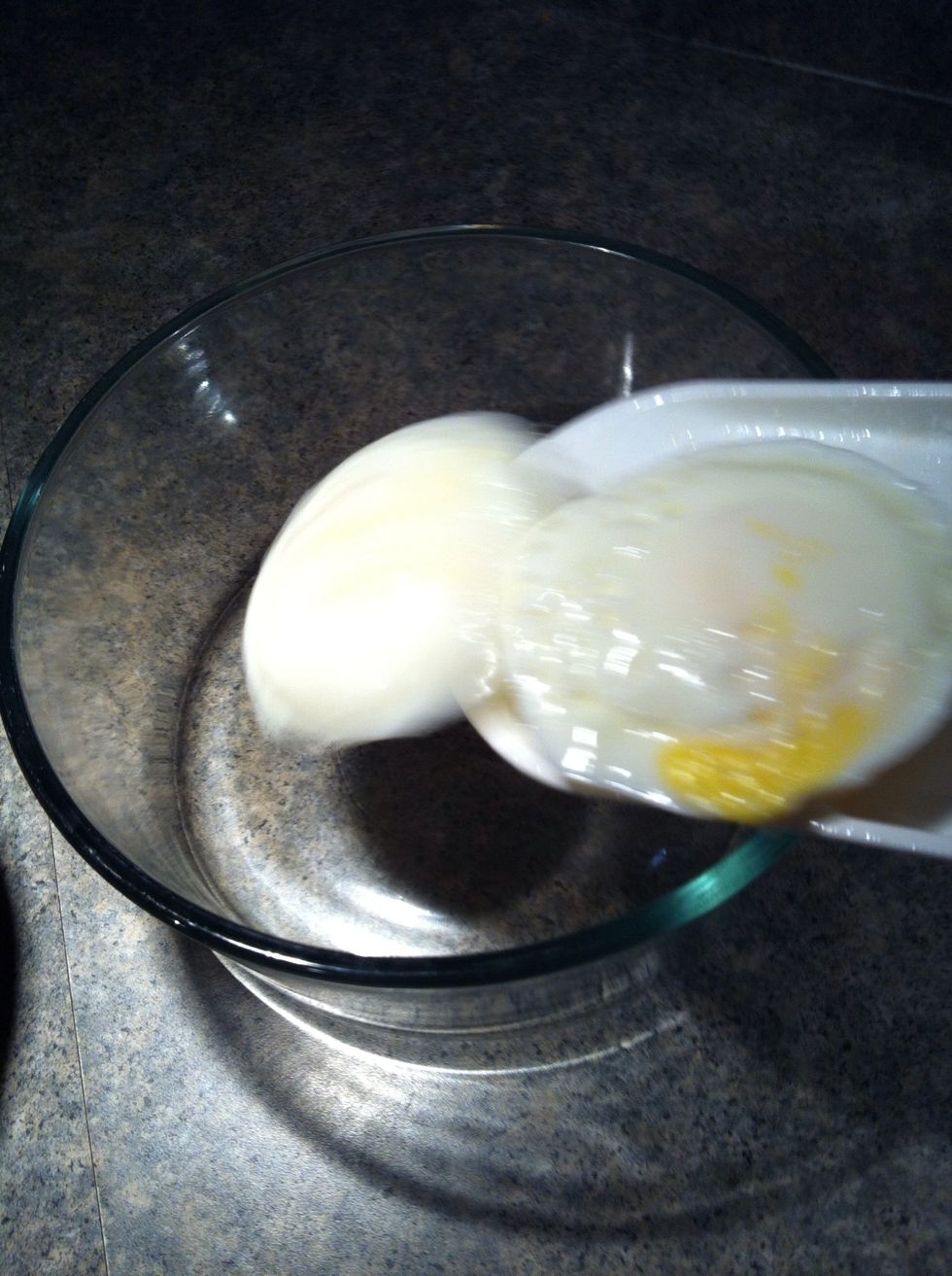 Slide cooked eggs into bowl