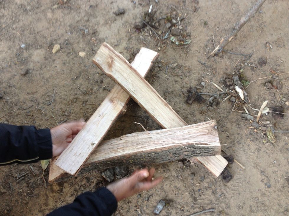 Slide in the third piece between the other two, one tip on the ground and the other on top of the second piece