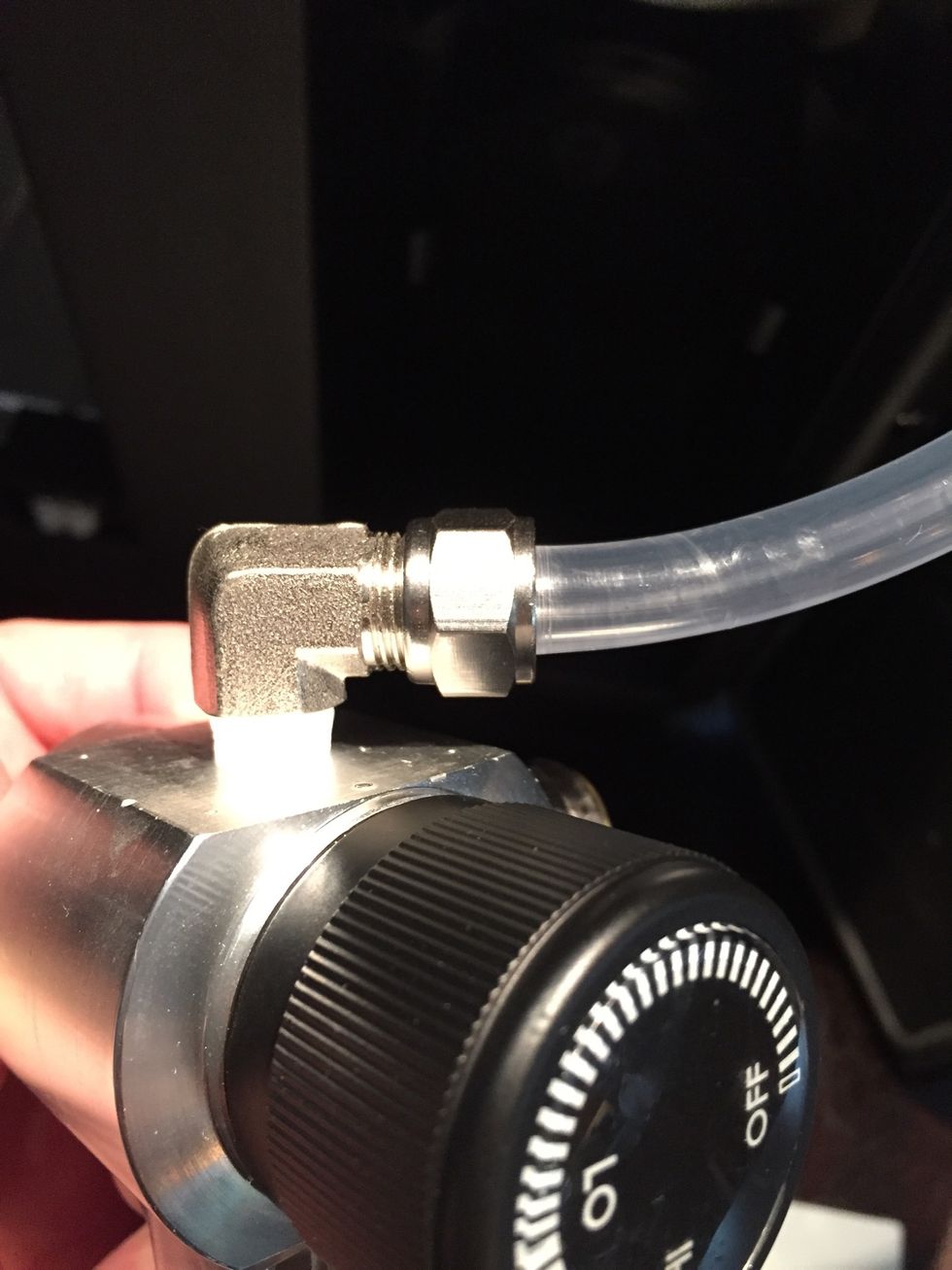 Slide nut down the hose and screw into regulator.