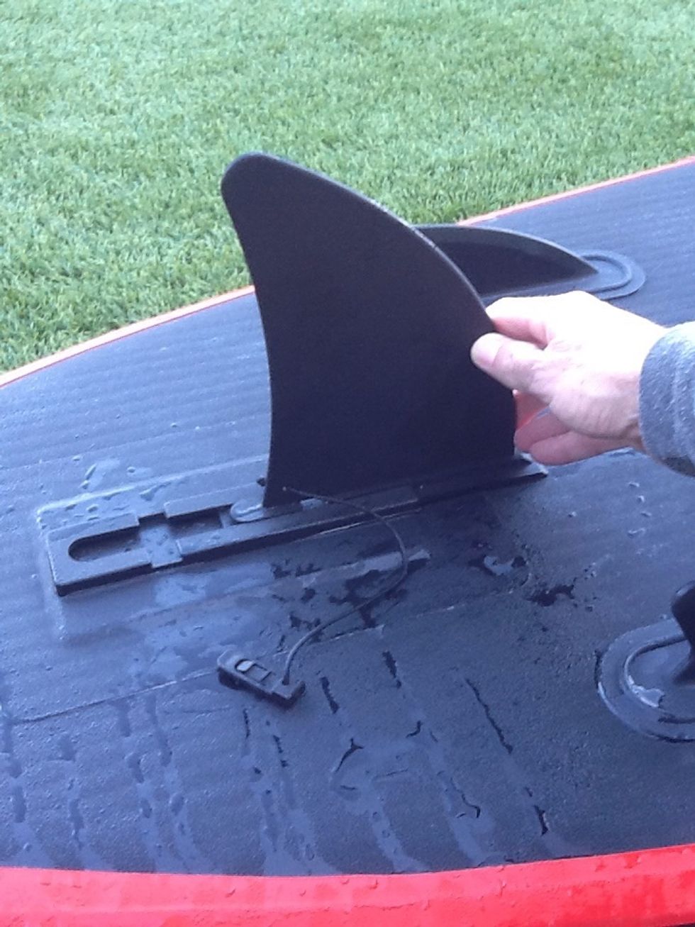 Slide & Snap - Step 2 - begin sliding the fin back through the groove. Be aware of sand that may block the groove. It should slide with a little force and should be snug.