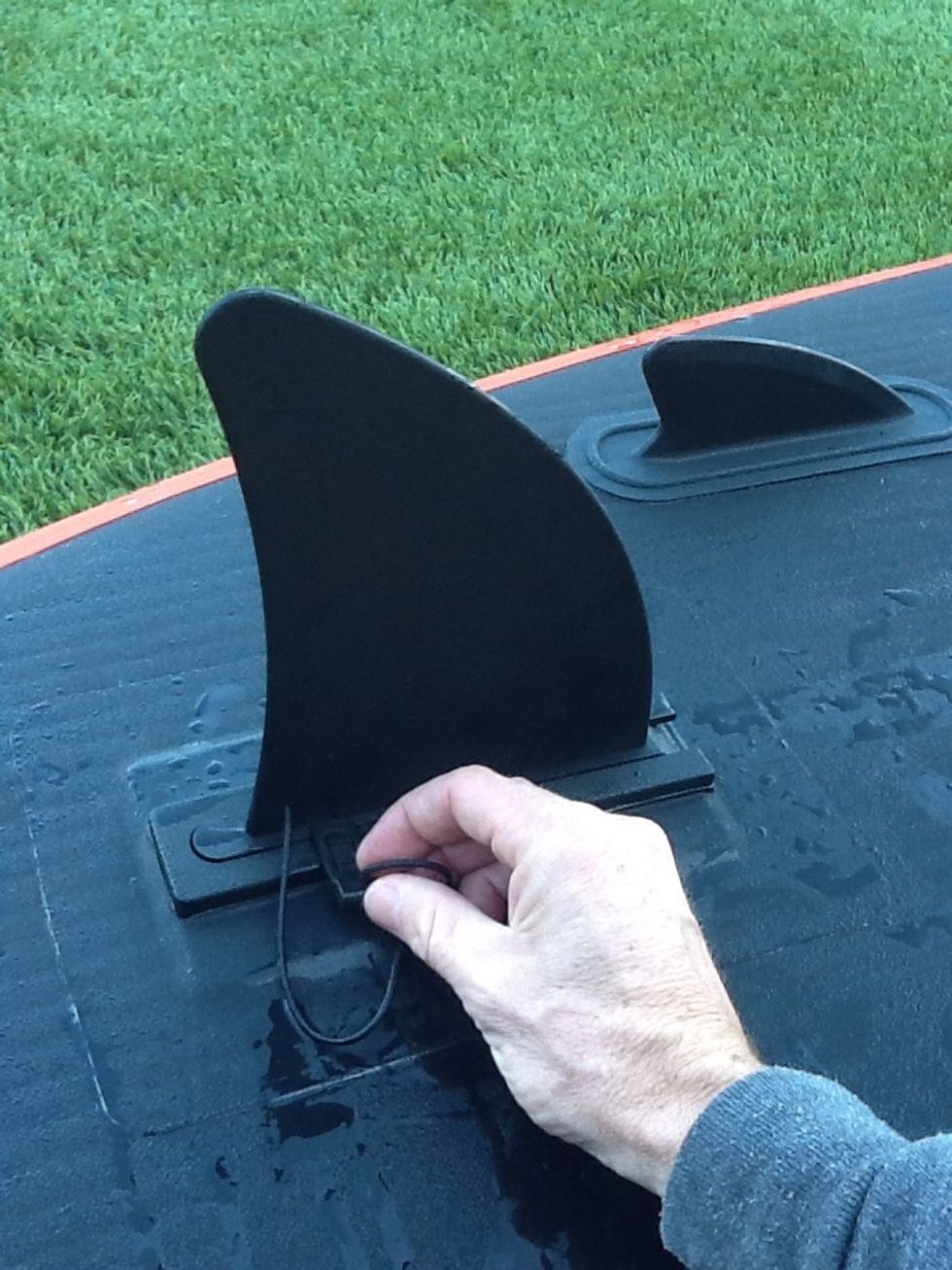 Slide & Snap - Step 3 - insert the tethered piece into the groove. It should be snug but not impossibly tight. If it is too tight to slide then you need to push the fin back more or clear sand.