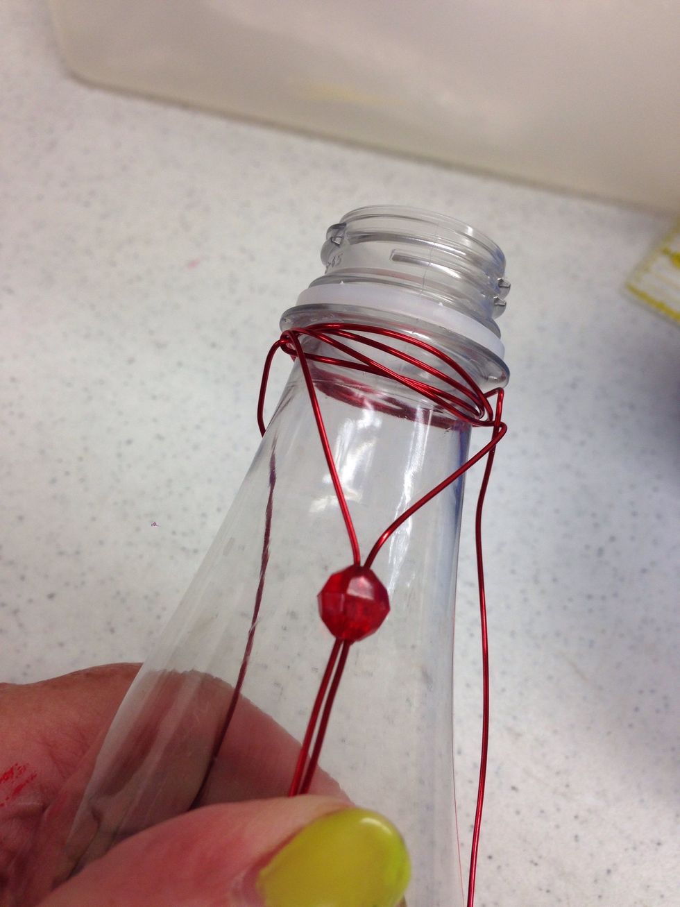 Slide the bead up the set of wires until it's difficult to move it any further.