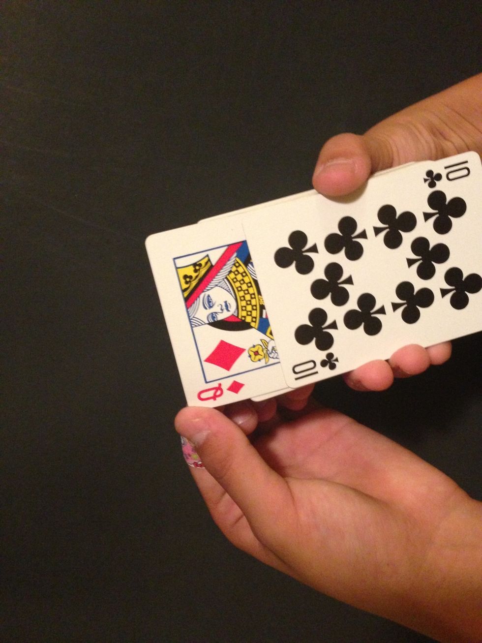 Slide the bottom card back just enough for them not to notice.