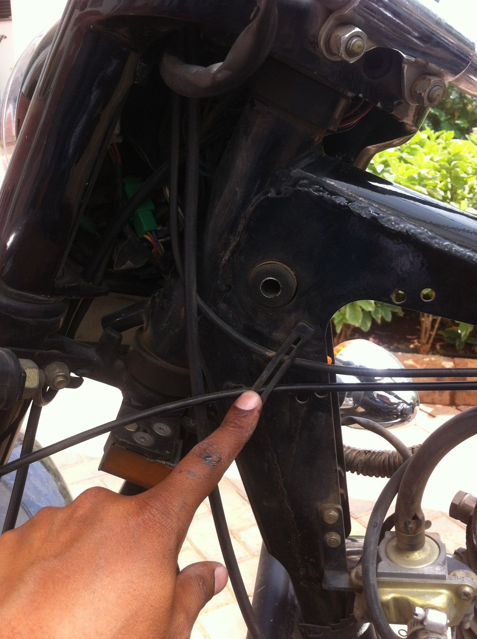 Slide the cable out of the frame clip. Take a moment to understand the cable routing at this stage.