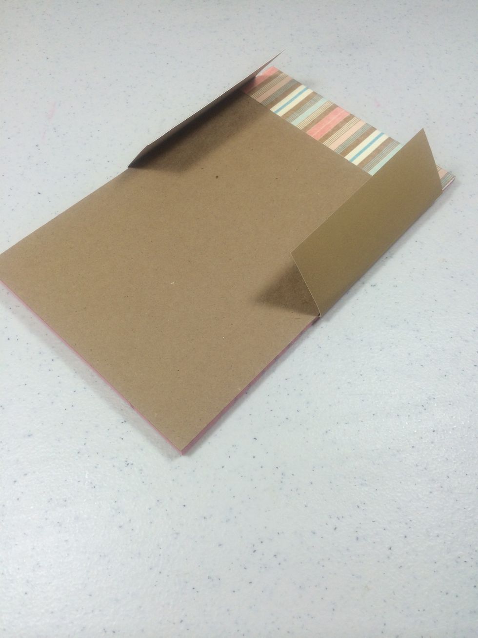 Slide the cardstock piece behind the last page in the steno pad. Lay face down and gently fold both ends around the pad as shown.
