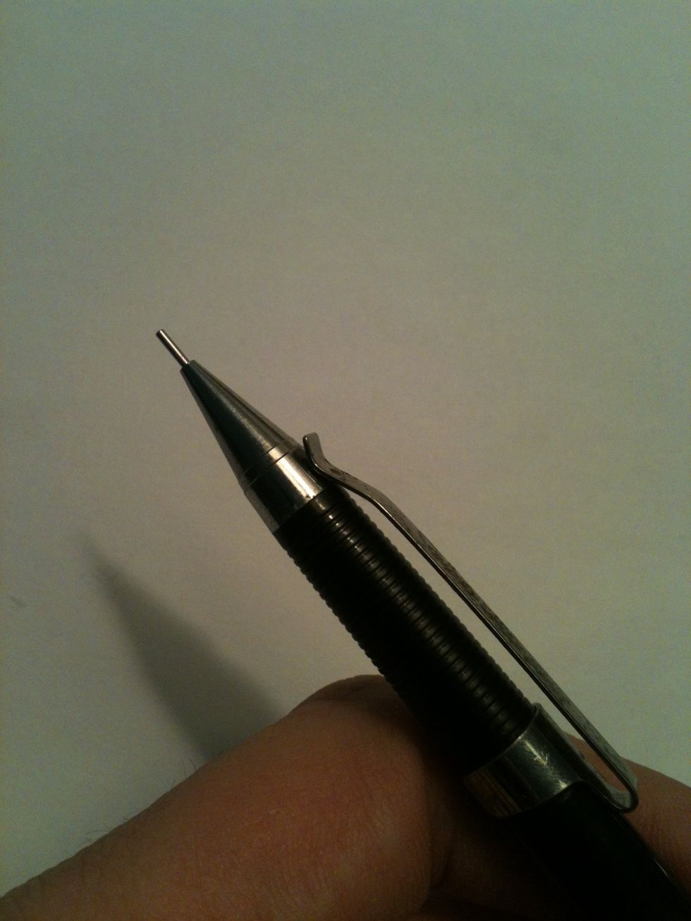 Slide the clip down so that the end of the clip makes contact with the metal on the tip of the pencil.