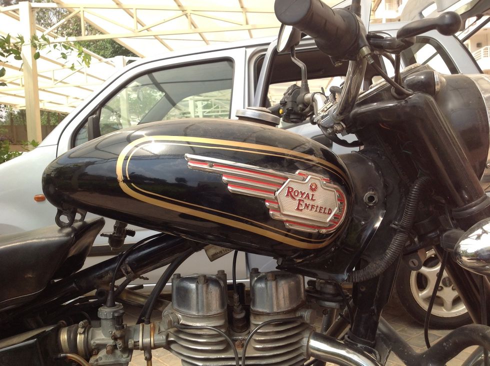 Slide the front in and avoid the bolts of the handle bar holder from scratching the tank paint job