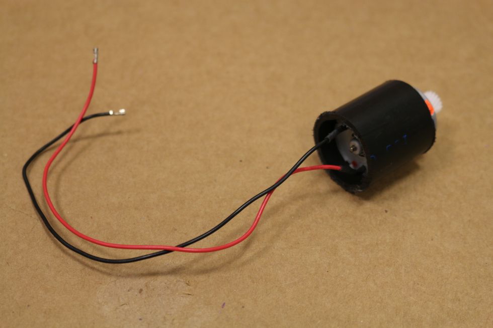 Slide the motor inside the PVC tube while the hot glue still hot.  Add some more hot glue to make sure the motor stays in. Careful not to get any hot glue on the shaft of the motor.