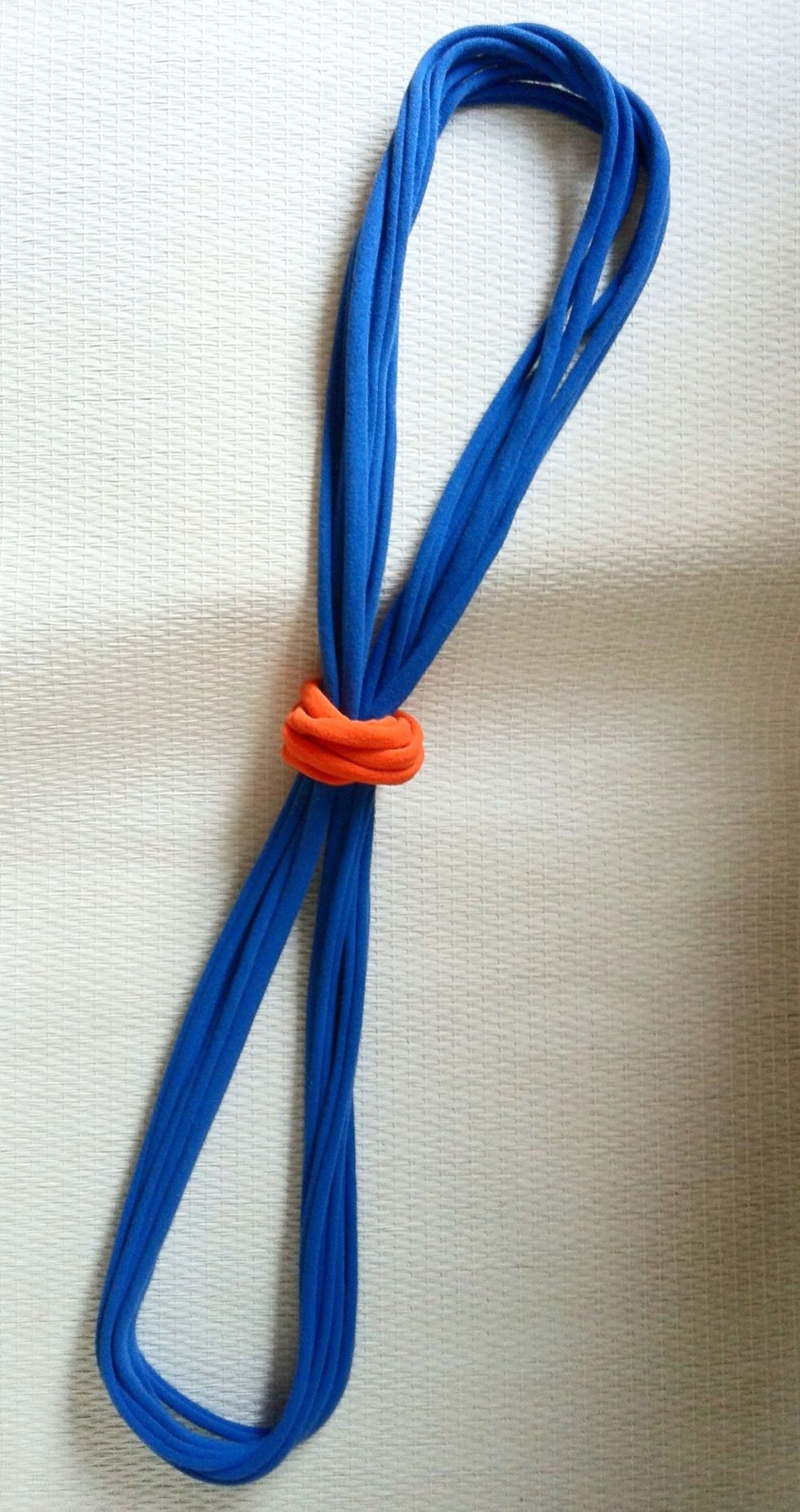 Slide the ring to the middle of the necklace strands being careful not to twist the necklace strands - keep them separated and side by side....important for the next step.