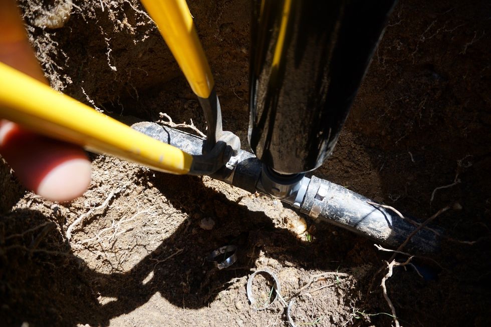 Slide the steel clamp rings in place as seen and use the tool to clamp the rings tight.