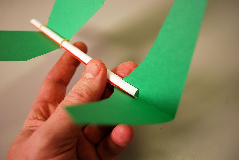 Slide the tail inside the cut staw.