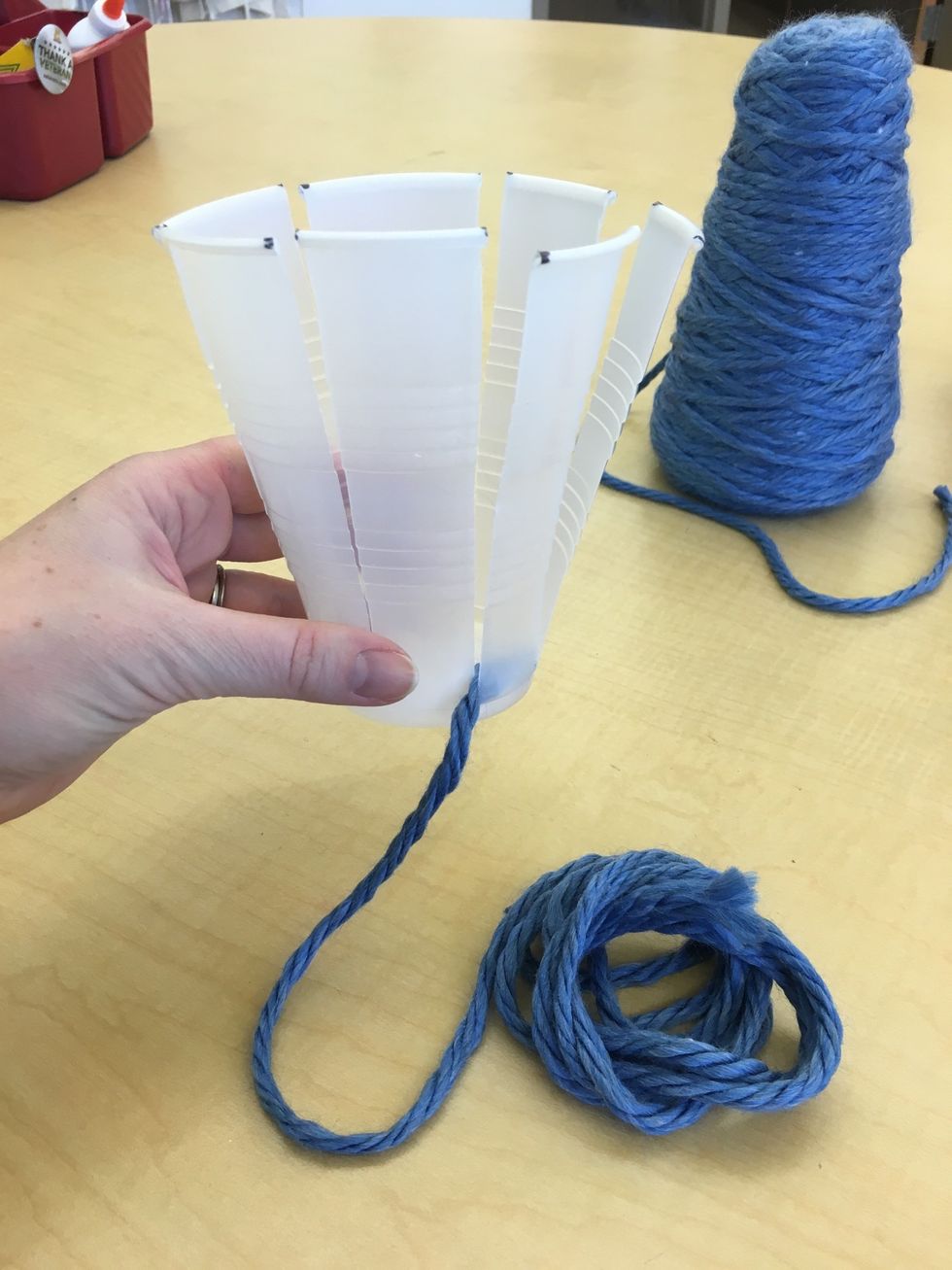 Slide the top of the yarn to the bottom of the cup.