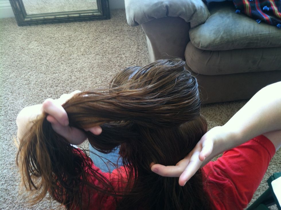 Slide your finger to pick up more hair while picking your middle section back up